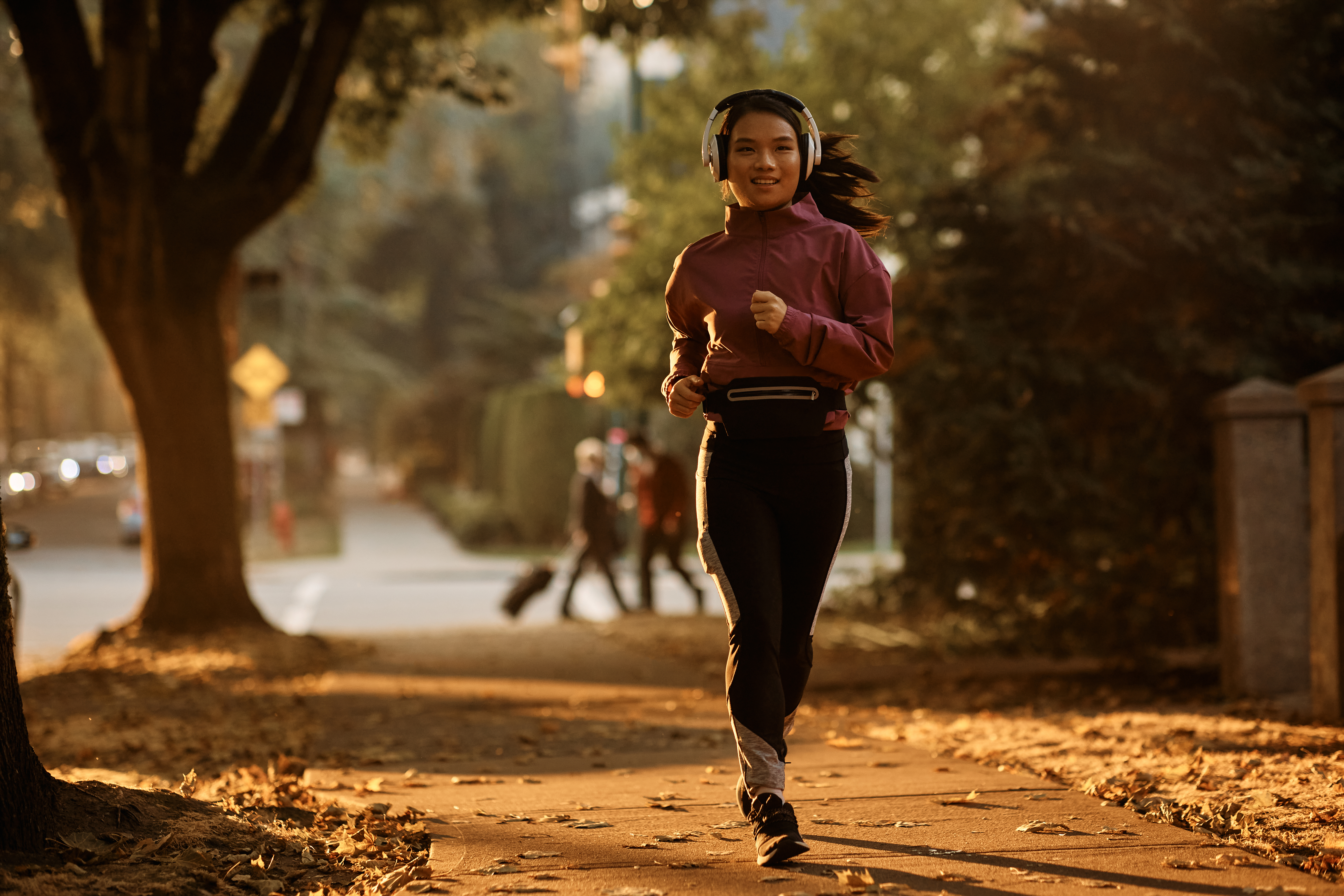 Full length of Asian sportswoman jogging on the street.